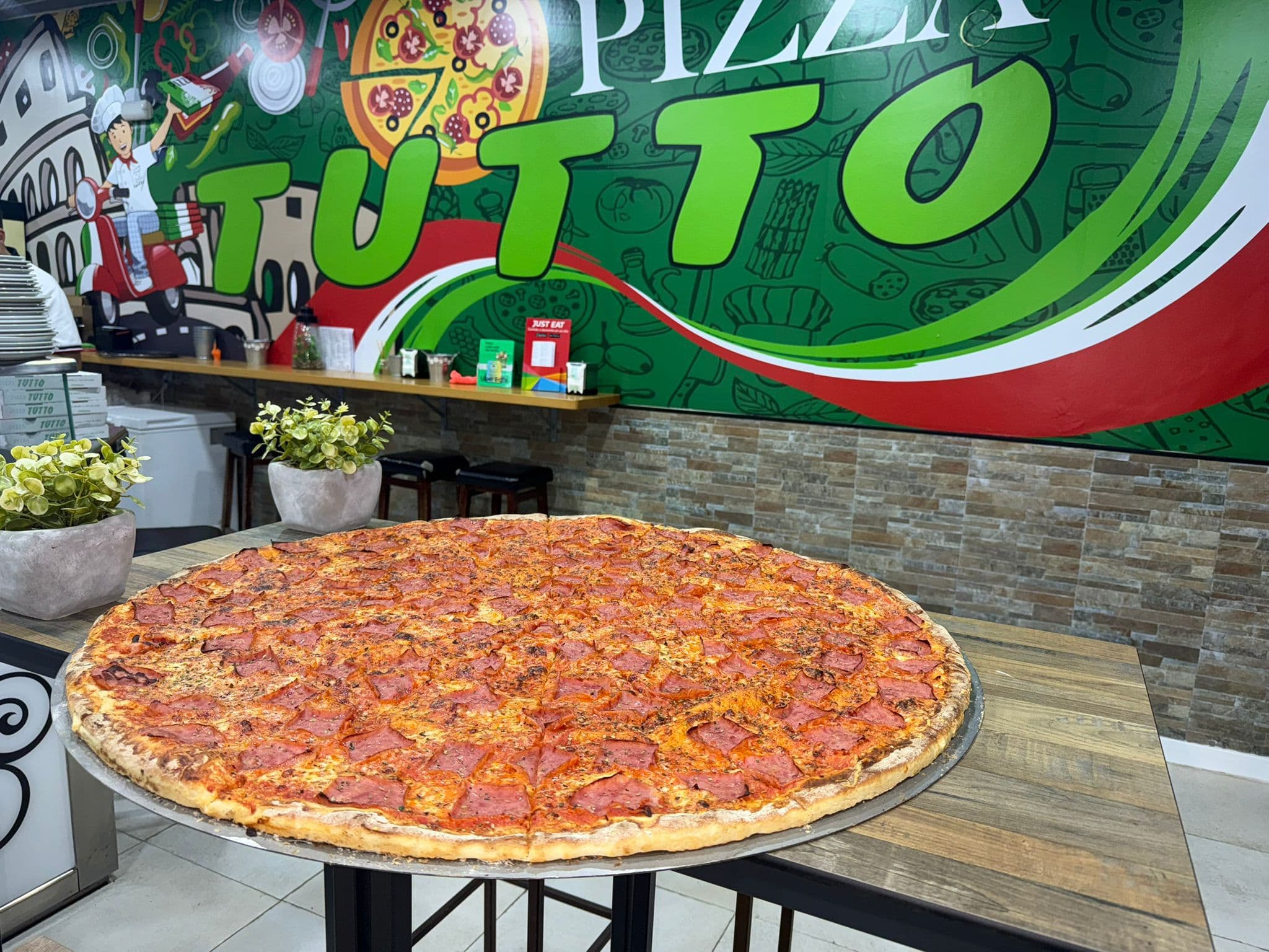 Pizza recién preparada en Pizza Tutto